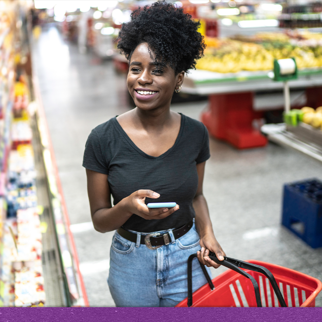 Smiling woman shopping in a grocery store